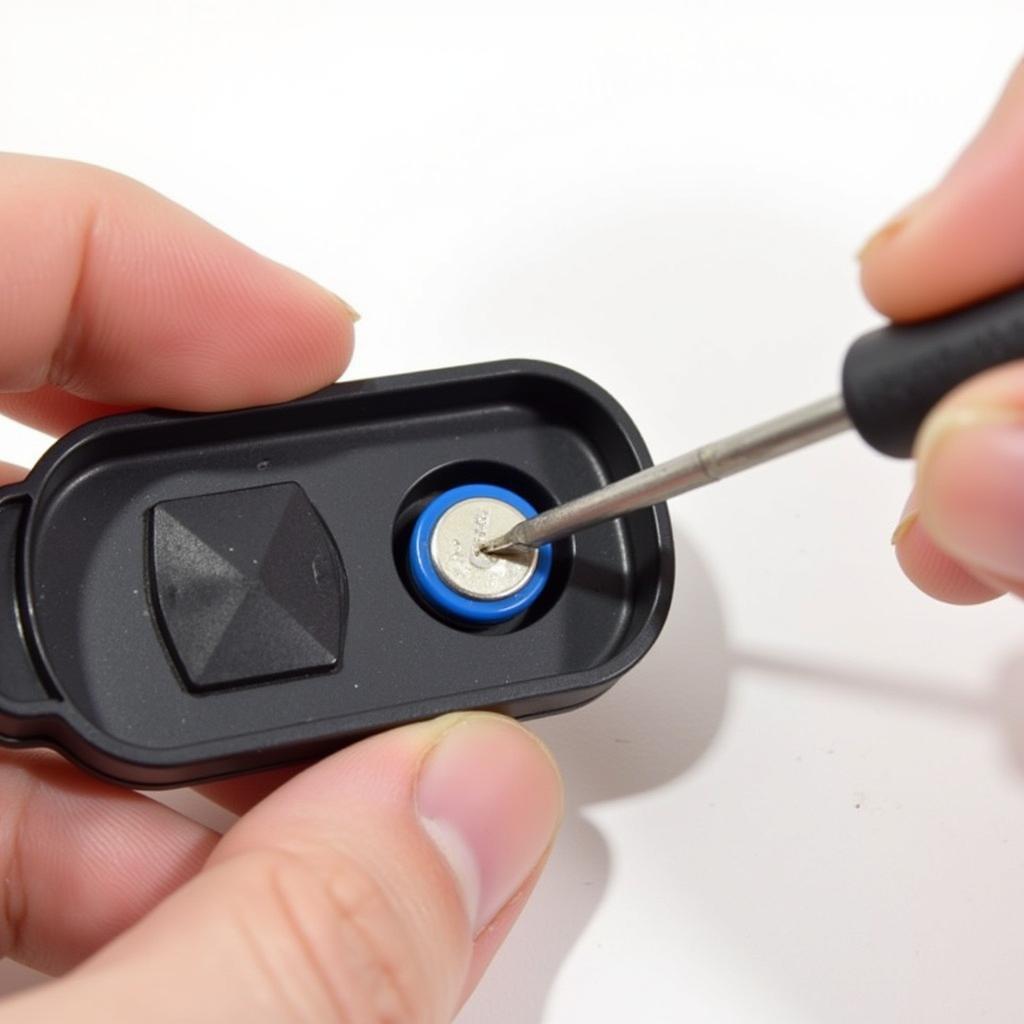 Removing the old battery from a 2015 Toyota Corolla key fob