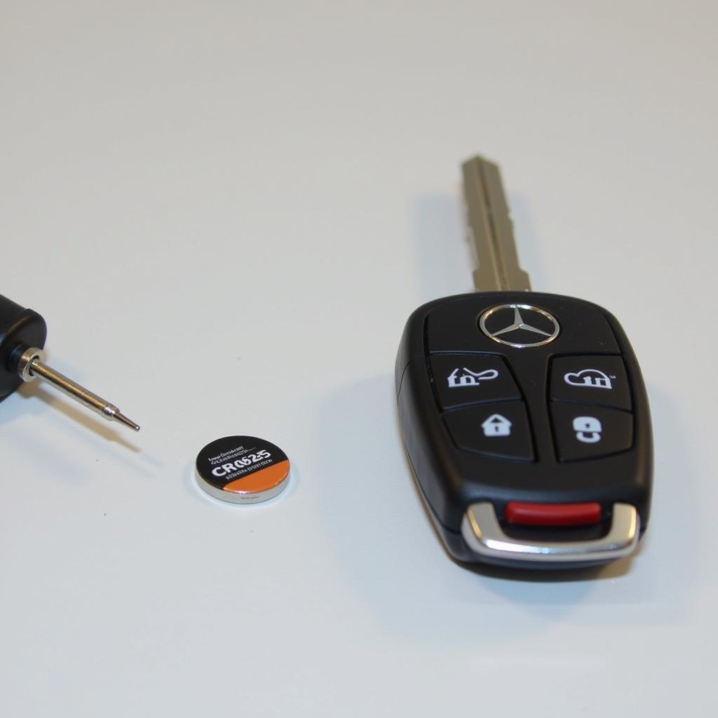 Tools needed for a 2015 Mercedes ML350 key fob battery replacement: flathead screwdriver, CR2025 battery