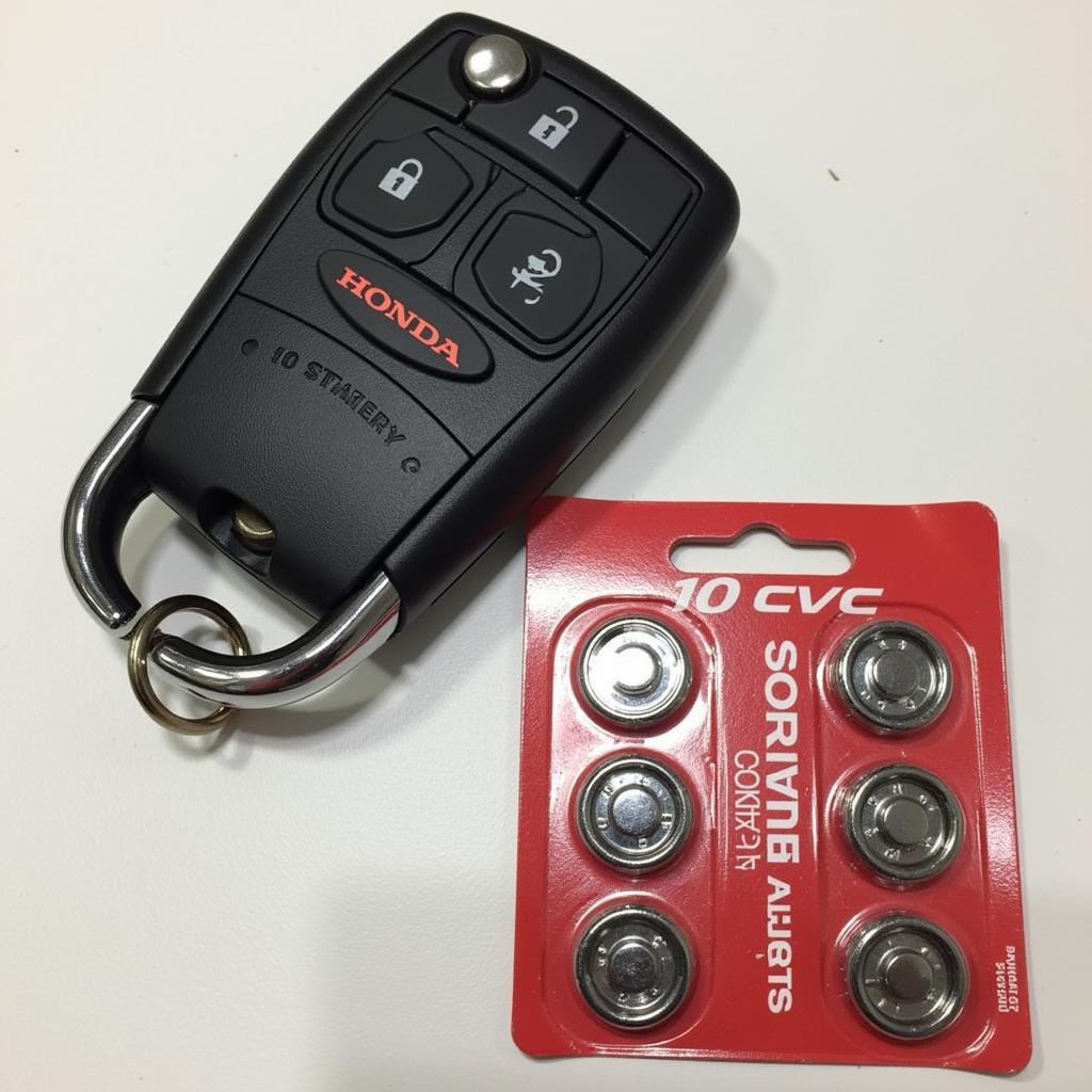 2016 Honda Civic key fob and a pack of CR2032 batteries