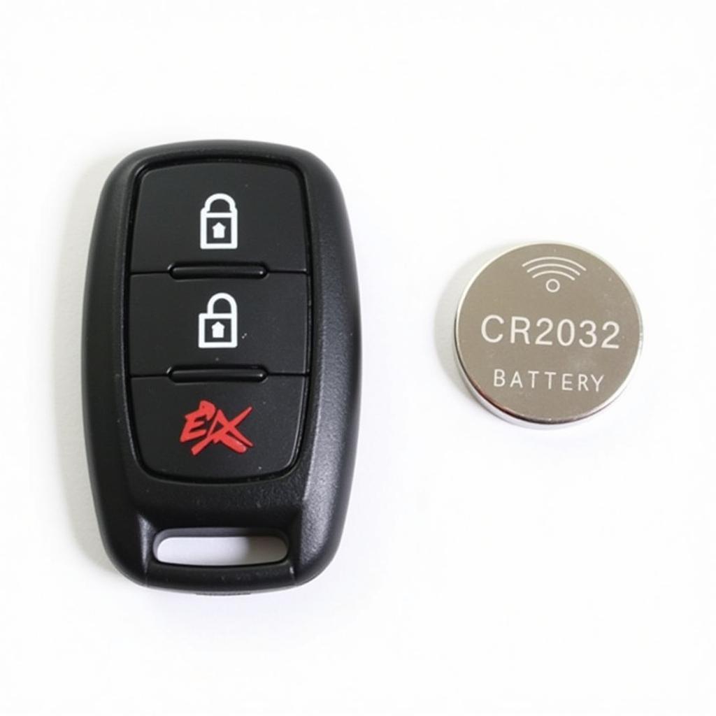 2016 VW Golf key fob with a CR2032 battery placed next to it for comparison.