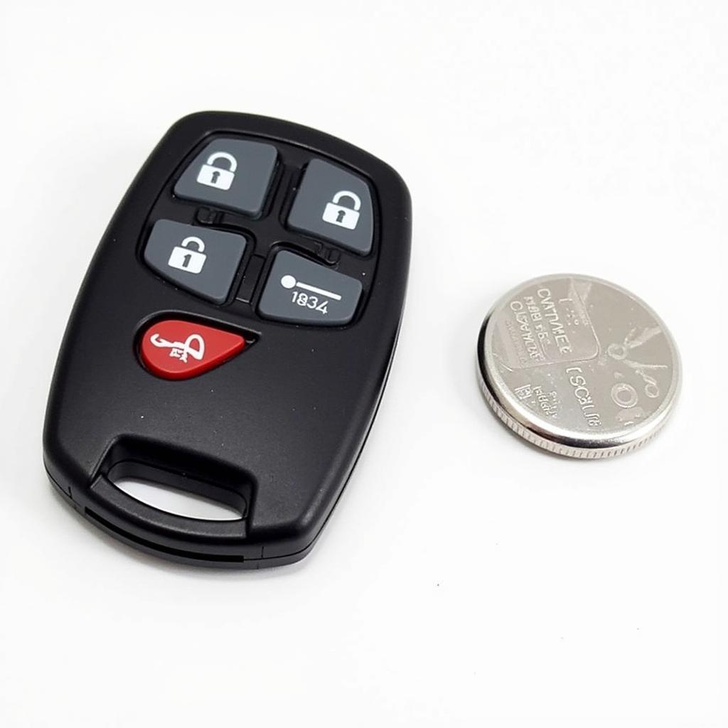 2018 Nissan Versa Key Fob Battery Identification: Close-up view of a CR2032 battery next to a 2018 Nissan Versa key fob, highlighting the correct battery type for replacement.