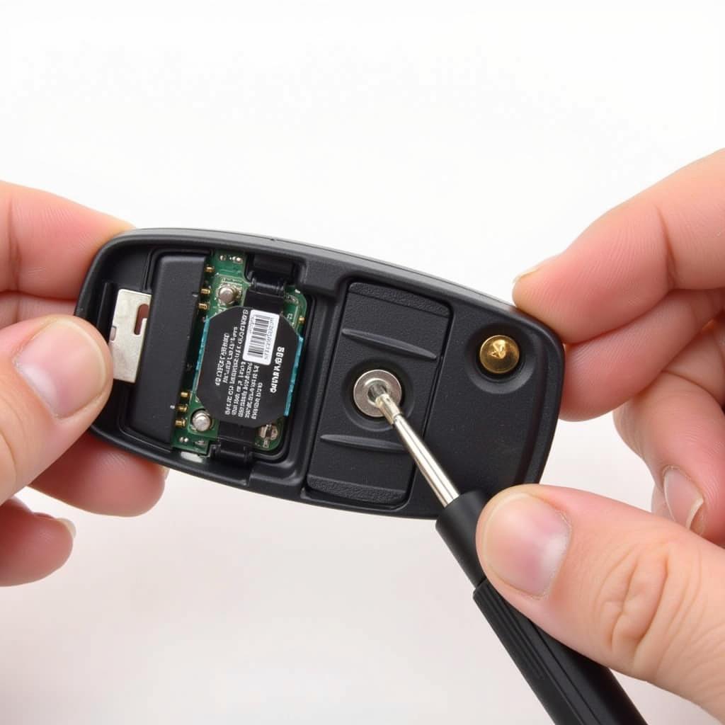 Removing the old battery from a 2019 Buick Enclave key fob