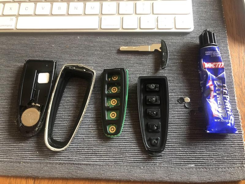 Ford key fob disassembled to show internal components for repair