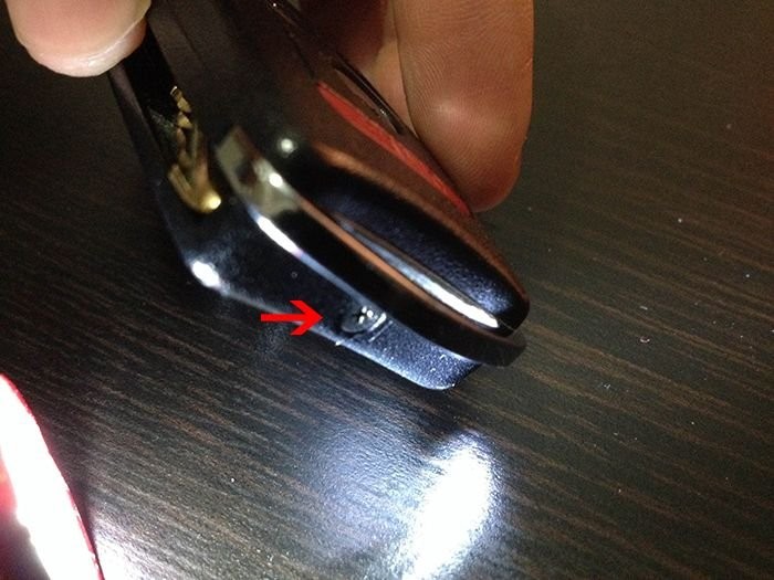 Removing the screw from the switchblade key fob housing.