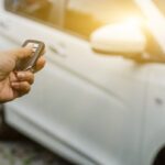 driver pressing a car key fob