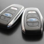 Using a car key fob to start a vehicle, illustrating keyless ignition technology.