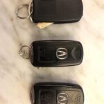 Acura MDX key fob options showing different button configurations for SUV liftgate and car trunk, part number variations