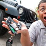 Close up of hand prying open a key fob to replace the battery