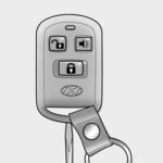 Opening the Hyundai Elantra key fob case with a flathead screwdriver to access the battery compartment.