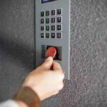 Close up of a hand using a key fob copy to open a door.