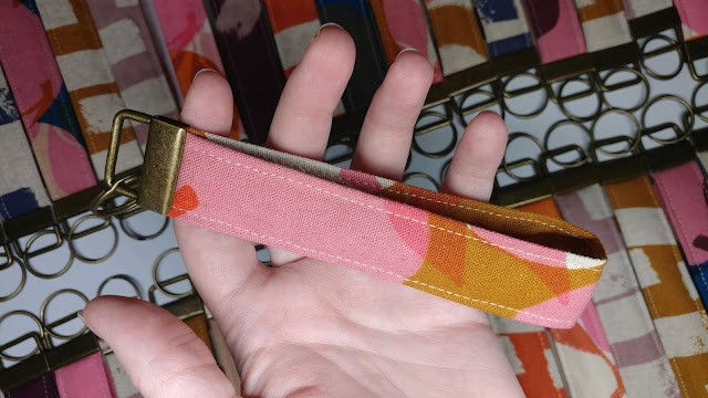 Close-up of a handmade key fob wristlet showcasing fabric and hardware