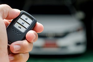 Honda key fob with remote start button highlighted, demonstrating car remote start feature