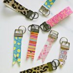 Close-up of handcrafted leather key fobs in various colors and designs, showcasing the versatility of Cricut for leather crafting