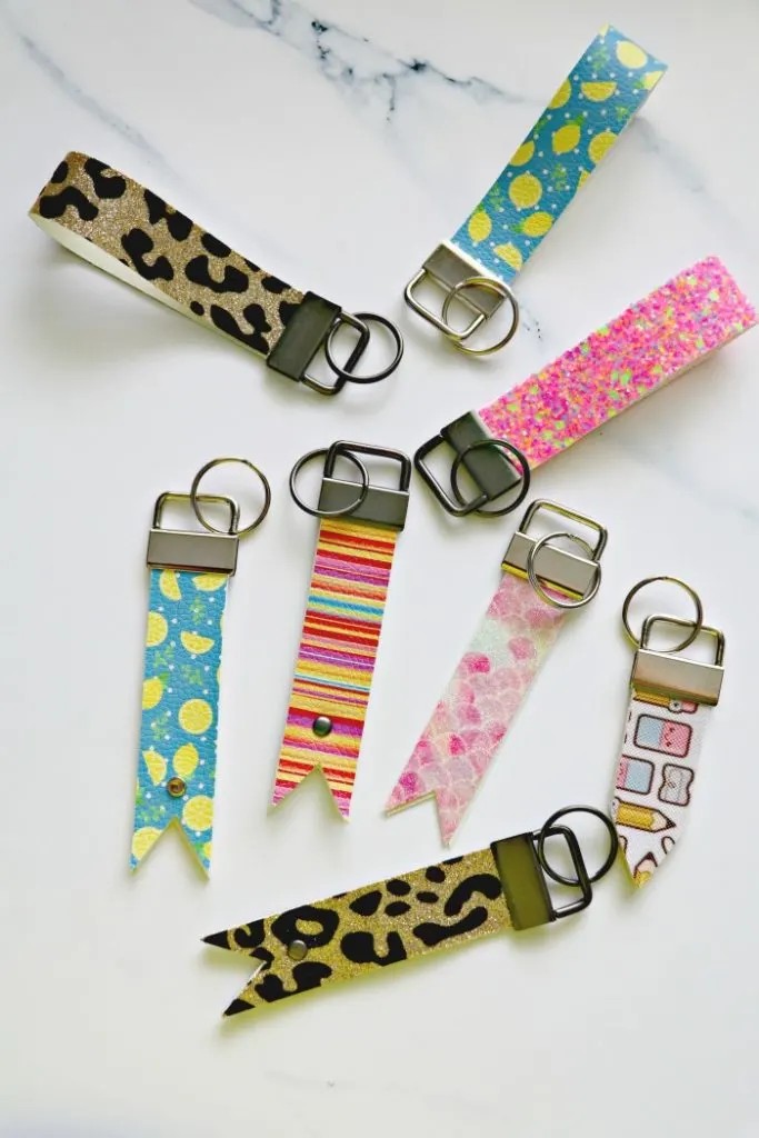 Close-up of handcrafted leather key fobs in various colors and designs, showcasing the versatility of Cricut for leather crafting