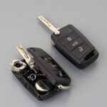 Car key fob battery replacement guide showcasing tools and a new battery