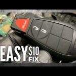 alt text: Opening the Dodge Caravan key fob to access the battery compartment using a screwdriver