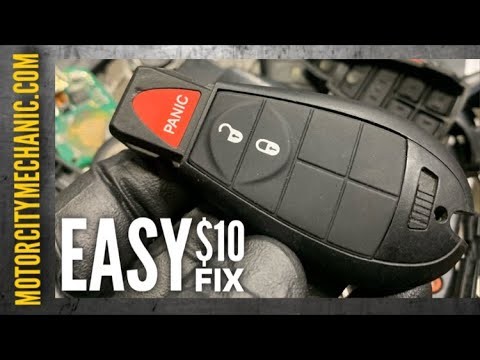 alt text: Opening the Dodge Caravan key fob to access the battery compartment using a screwdriver