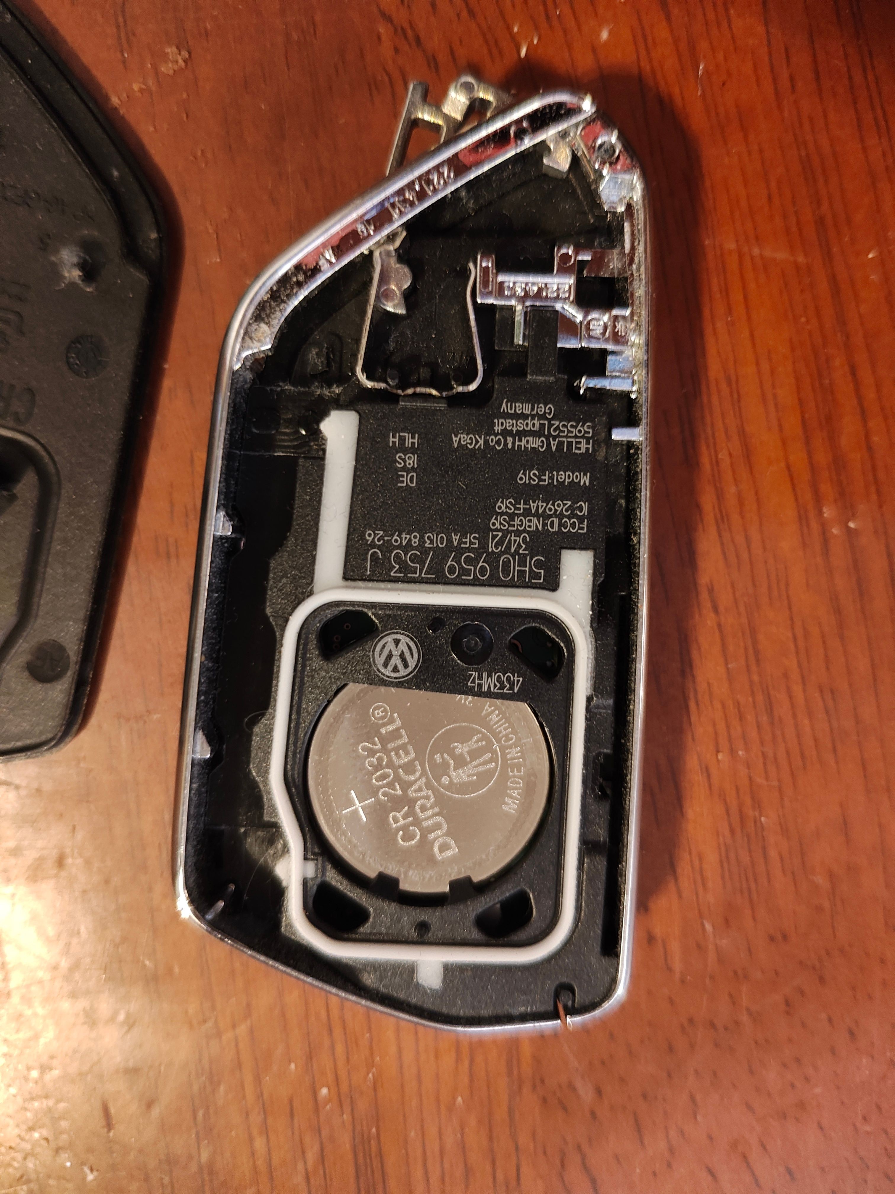 Close-up of a disassembled key fob showing the battery compartment and circuit board