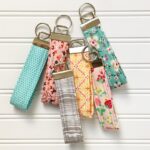 Selection of handmade fabric key fobs in various colors and patterns, showcasing different hardware sizes.