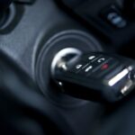 Car key in ignition with key fob buttons for illustrative purposes