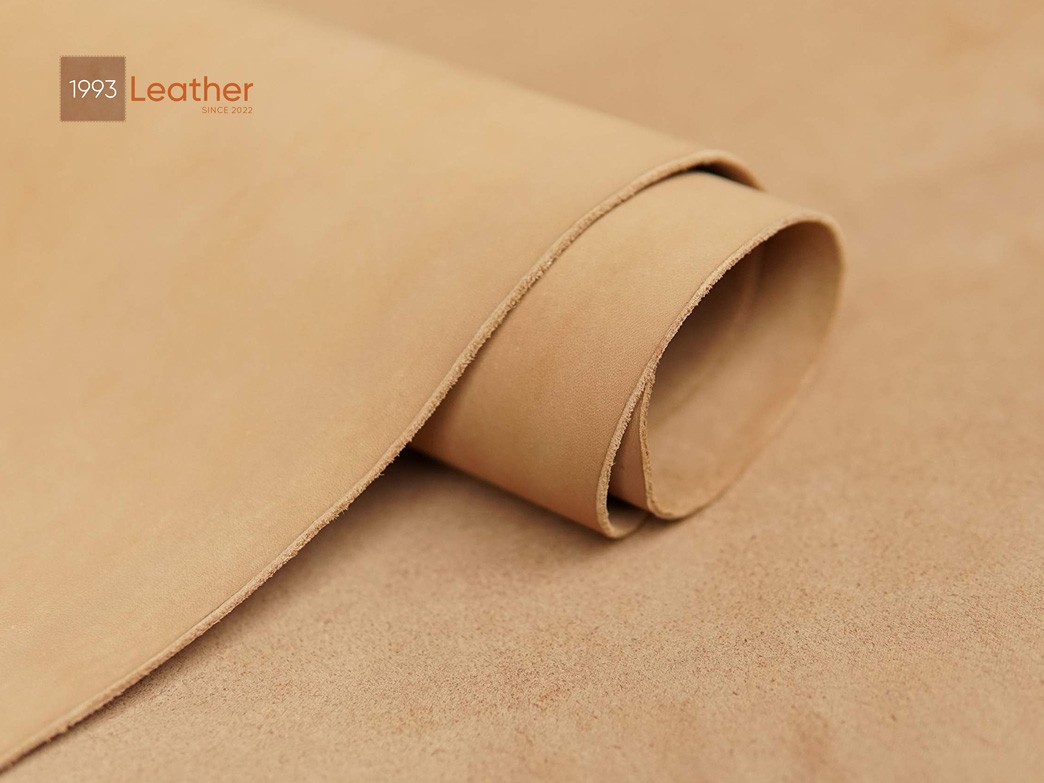 Close-up of vegetable-tanned leather, highlighting its texture and natural grain, used in a Ford Bronco key fob cover.